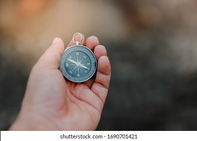 Hand and compass concept for use - Shutterstock ID 1690701421