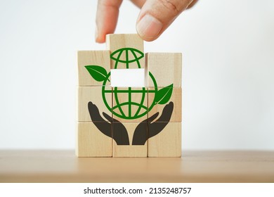 hand complete green globe icon on cube ,CSR, eco green sustainable living, zero waste, plastic free, earth day, world environment day, responsible consumption Social responsibility core value concept  - Shutterstock ID 2135248757