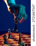 Hand completing chess move on illuminated board. Concept of gambling conclusion, finalized bets, outcome acceptance, result analysis, business performance, strategic closure.