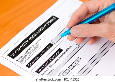 Hand Completing A University Application Form