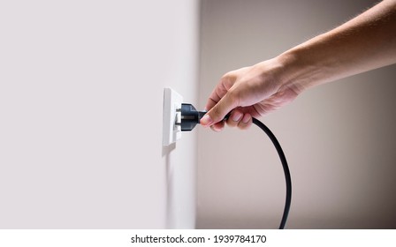 Hand Connecting Electrical Plug Cause Electric Shock, Idea For Causes Of Home Fire, Electric Short Circuit, Electrical Hazard Can Ignite Household Items