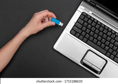 Hand connecting usb flash drive to notebook.