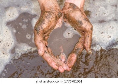 Hand copped with dirty water, Drought impact lack of drinking water.