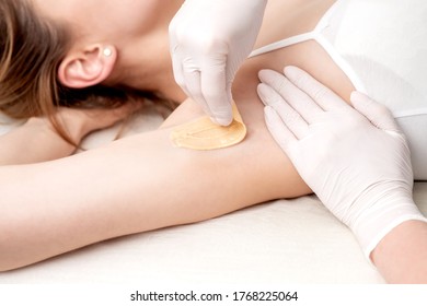 Hand Of Cosmetologist Applying Wax Paste On Armpit. Depilation Or Epilation Female Armpit With Liquid Sugar Paste. Smooth Underarm Concept