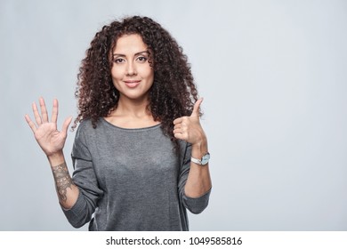 Hand Counting - Six Fingers. Smiling Woman Showing Six Fingers