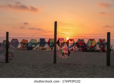 Hand Crafted Kites For Sale Displayed On A Fence At Gaza Sea Shore - Sunset Time