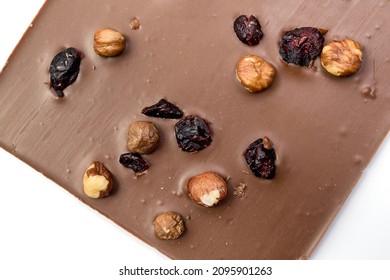 Hand Crafted Milk Chocolate With Hazelnuts, Raisins And Dried Fruits On White Background