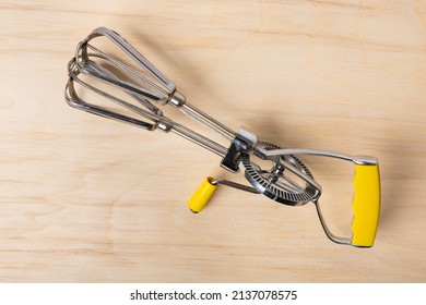 Hand Crank Egg Beaters With Yellow Handle.