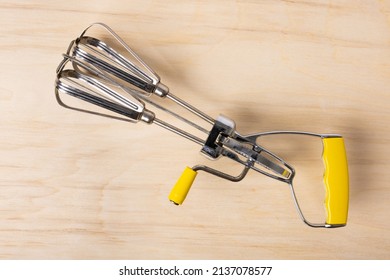 Hand Crank Egg Beaters With Yellow Handle.