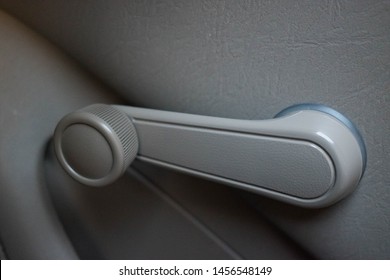 Hand Crank, Non-electric, Manual Car Window Knob In A Dove Grey Color An Old Vehicle. Changing Automobile Technology Concept.