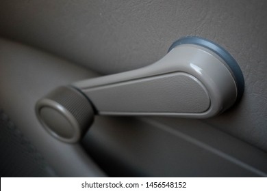 Hand Crank, Non-electric, Manual Car Window Knob In A Dove Grey Color An Old Vehicle. Changing Automobile Technology Concept.