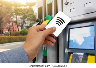 Hand With A Credit Card On The Background Of A Self-service Gas Station. Contactless NFC Payment 