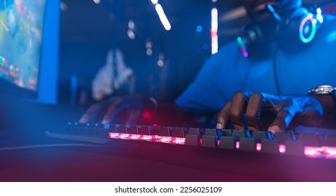 Hand of crypto trader African man working with money on exchange bitcoin kayboard neon color. Concept investor finance stocks and e-currency. - Shutterstock ID 2256025109