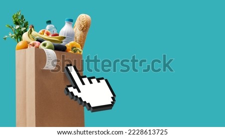 Hand cursor clicking on a full grocery bag, online grocery shopping concept