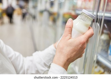 Hand Of A Customer When Shopping For Almond Milk Or Soy Milk At The Refrigerated Section In The Supermarket