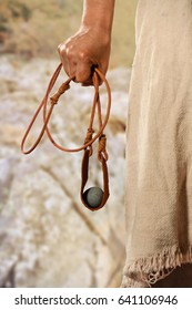 Hand of David holding slingshot with stone