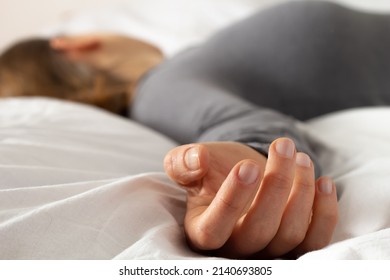 The Hand Of A Dead Woman Lying On The Bed. Corpse.