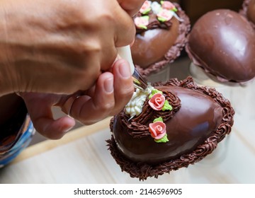 Hand Decorating A Chocolate Easter Egg With A Pastry Bag