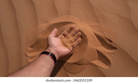 Hand in Desert Sand Close-up - Powered by Shutterstock