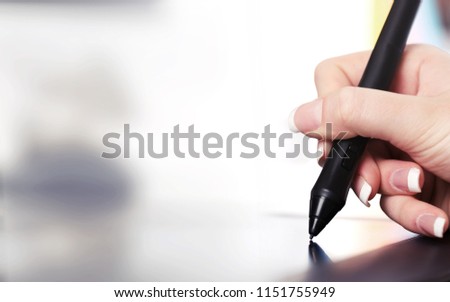 Hand of the designer with a pen