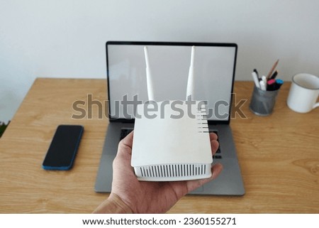 Hand of developer showing wifi router