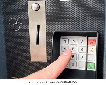 hand dials a code of numbers on a parking machine, protection, password - Powered by Shutterstock - Get 15% off with code: PIKWIZARD15