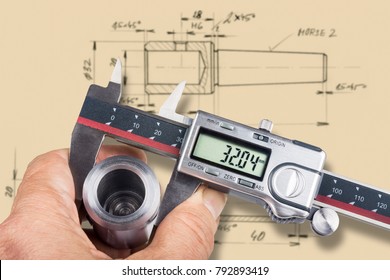 Hand And Digital Measuring Tool. Machinist Gauges The Diameter Of Metal Workpiece By The Caliper And Checks It With Technical Documentation.