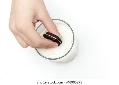 Hand Dipping Cookies In Milk On A White Background