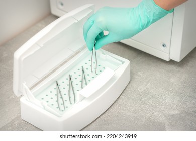 Hand Disinfects Tweezers With Cleaning Systems For Medical Instruments. Ultrasonic Cleaner