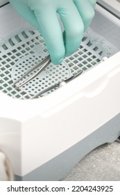 Hand Disinfects Tweezers With Cleaning Systems For Medical Instruments. Ultrasonic Cleaner