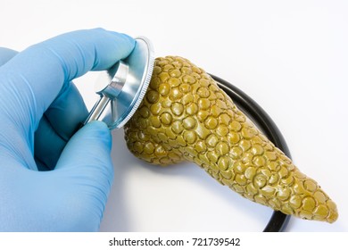 Hand of doctor in glove with stethoscope and 3D shape of pancreas. Photos idea where surgeon or general practitioner conducts preoperative diagnosis or diagnosis of disease of pancreas gland