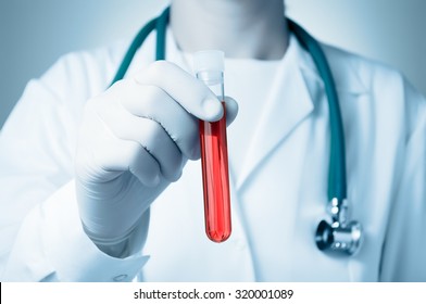 Hand Of A Doctor Holding A Bottle Of Blood Sample