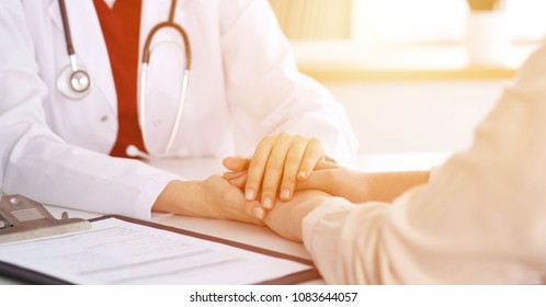 Hand Of Doctor  Reassuring Her Female Patient