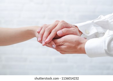 Hand Of Doctor Reassuring Her Female Patient.