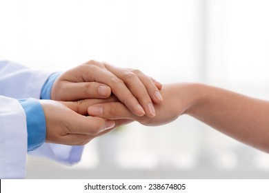 Hand of doctor reassuring her female patient - Powered by Shutterstock