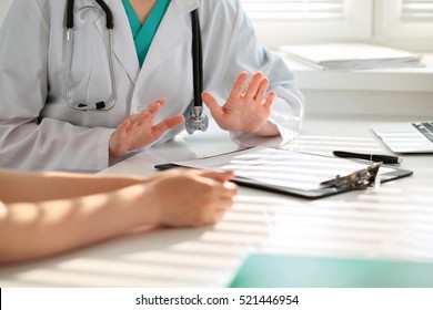 Hand of doctor  reassuring her female patient. Medical ethics and trust concept