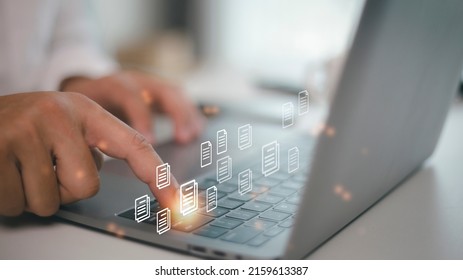 Hand With Document Icons And Typing To Laptop Computer.