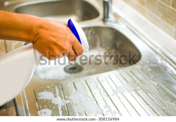 hand doing chores in the kitchen sink with spray cleaner degreaser kitchen People Purity Home Interior Shiny Woman