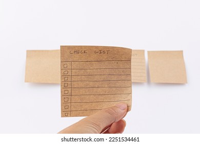 hand draw checklist on note taped recycle paper