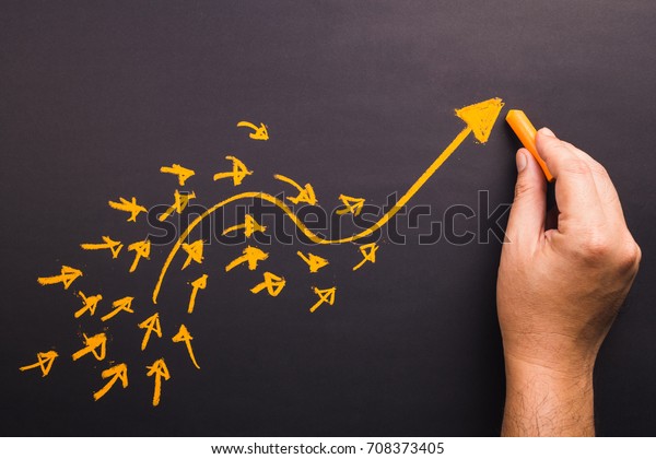 Hand draw a curve arrow leader with many small\
follower on chalkboard