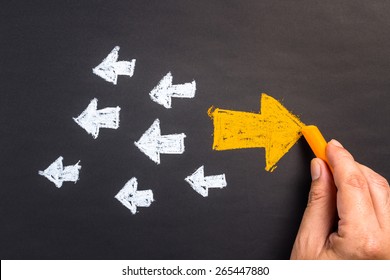 Hand drawing arrow sign in opposite direction from others - Shutterstock ID 265447880