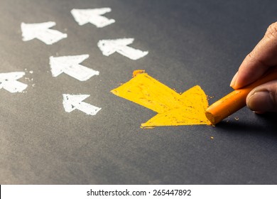 Hand drawing arrow sign in opposite direction from others - Shutterstock ID 265447892