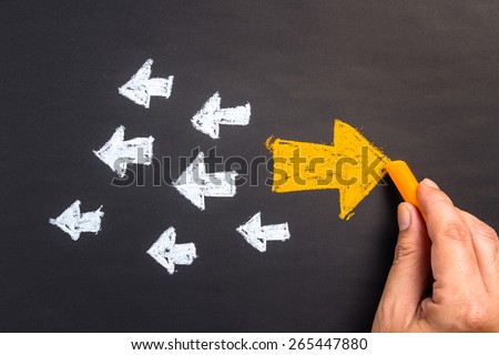 Hand drawing arrow sign in opposite direction from others