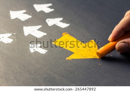 Hand drawing arrow sign in opposite direction from others