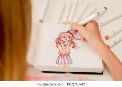 Hand drawing a cute girl anime style sketch with alcohol based sketch drawing markers. - Shutterstock ID 1912743943