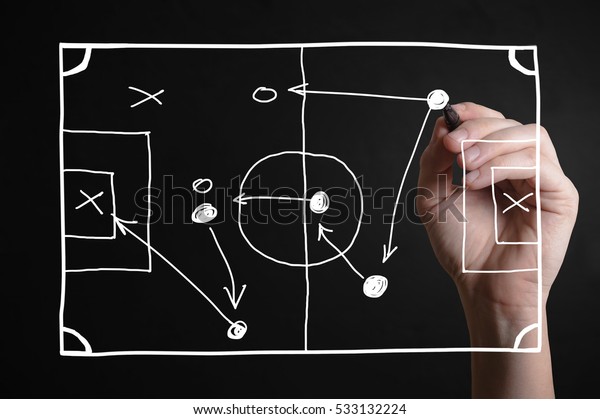 Hand drawing a football strategy plan drawn on a\
virtual screen