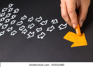 Hand drawing orange arrow as trend leader with many white arrows as follower - Shutterstock ID 353531480