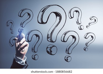 Hand drawing question marks. FAQ and enquiry concept. Close up