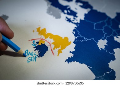 Hand Drawing A Red Line Between The UK And Northern Ireland, Backstop And Brexit Concept. The Backstop Solution For The Irish Border Is One Of The Main EU And UK Negotiations.