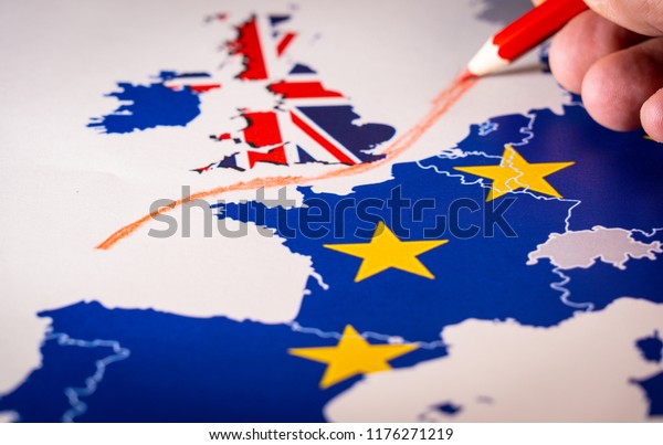 Hand drawing a red line between the UK and the rest of\
the European Union. Concept of Brexit. The UK is thus on course to\
leave the EU 